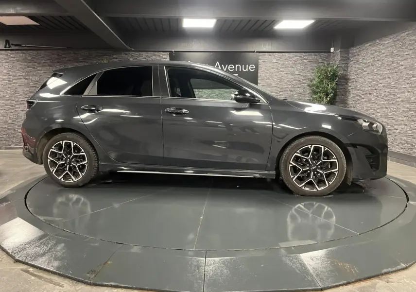 Profil côté gauche d'une KIA Ceed gris métallisé 2023 avec jantes alliage 17'' et vitres surteintées.