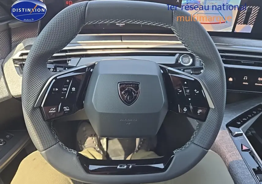 Vue rapprochée du volant cuir perforé noir avec logo Peugeot et inscription GT du Peugeot 3008 Hybrid 145 GT e-dcs6 2025.