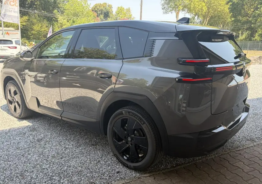 Vue 3/4 arrière gauche d’un Citroën C5 Aircross gris avec jantes noires et feux arrière horizontaux LED.