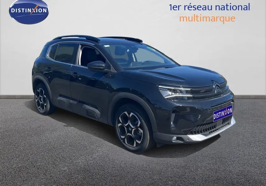 Citroën C5 Aircross noir métal en 3/4 avant droit, SUV hybride avec jantes distinctives et calandre moderne.