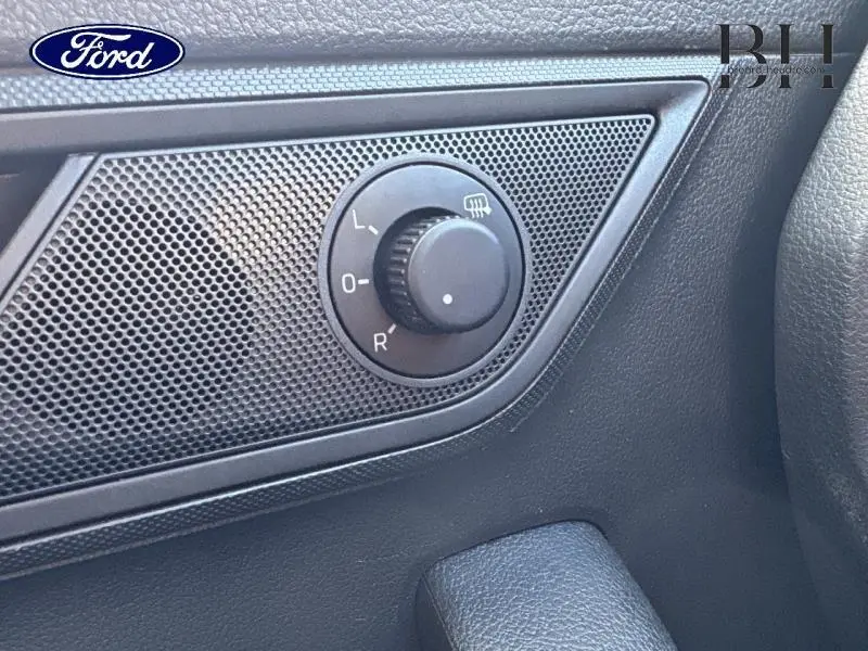 Gros plan sur le réglage des rétroviseurs côté conducteur dans l'habitacle gris d'une Skoda Fabia 2021