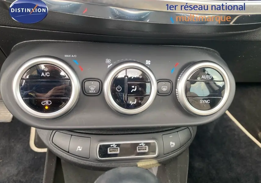 Commandes de climatisation et ports USB du tableau de bord du FIAT 500X bleu Venezia Metal, vue frontale rapprochée.