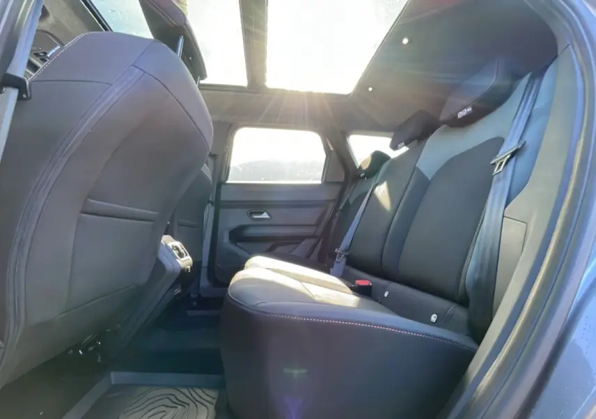 Vue intérieure arrière côté droit du Dacia Bigster gris schiste, avec banquette en cuir et toit ouvrant panoramique lumineux.