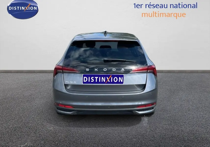Vue arrière d'une Skoda Scala gris graphite métallisé, avec feux arrière allongés et hayon fermé.