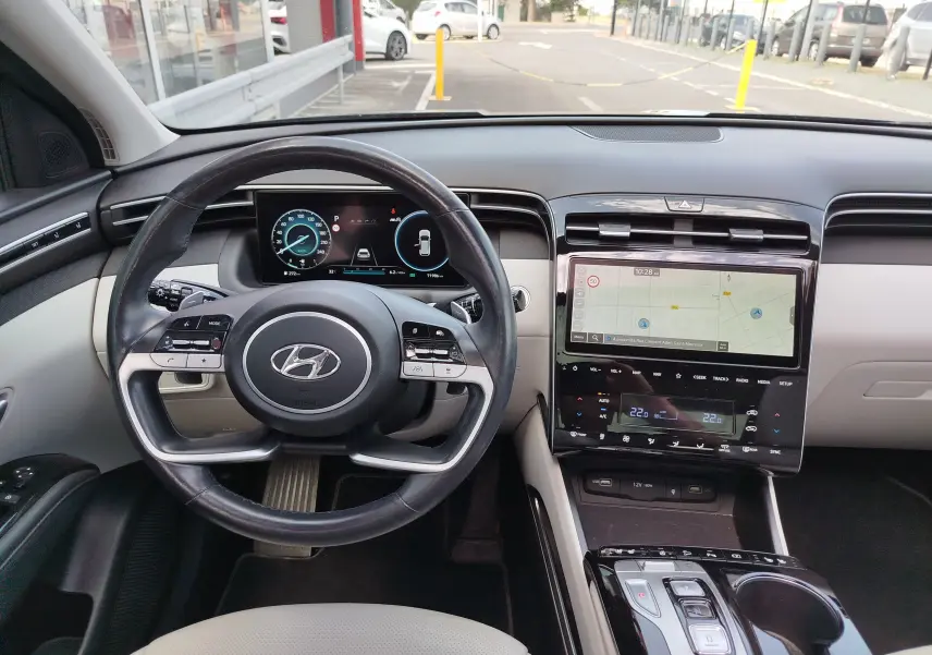 Vue intérieure du tableau de bord et volant du Hyundai Tucson 2021 avec écran tactile central et affichage numérique.