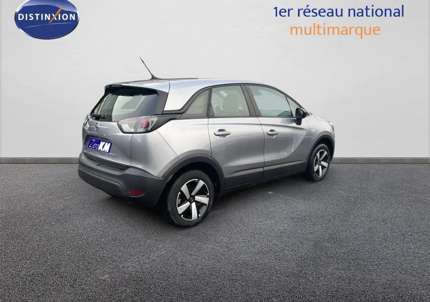 Opel Crossland gris minéral métal vu de trois quarts arrière droit, avec toit noir et jantes distinctives.