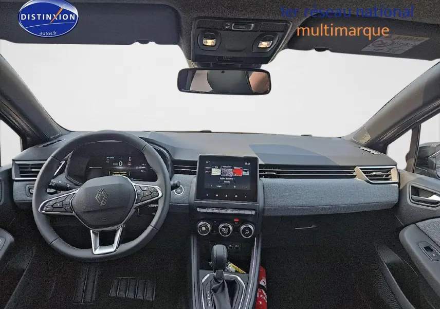 Vue intérieure avant de la Renault Clio V gris schiste, tableau de bord moderne avec écran tactile central et volant multifonction.