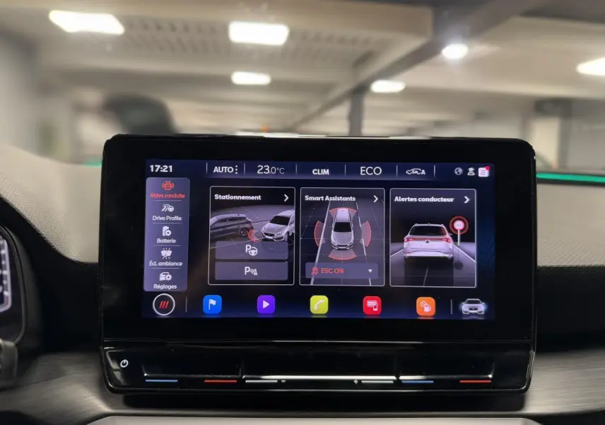 Écran tactile central affichant les aides à la conduite dans l'habitacle du CUPRA Leon Sportstourer rouge.