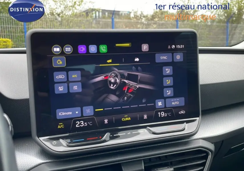 Écran tactile central affichant les commandes de climatisation et la vue intérieure du tableau de bord du SEAT Leon ST 2025.