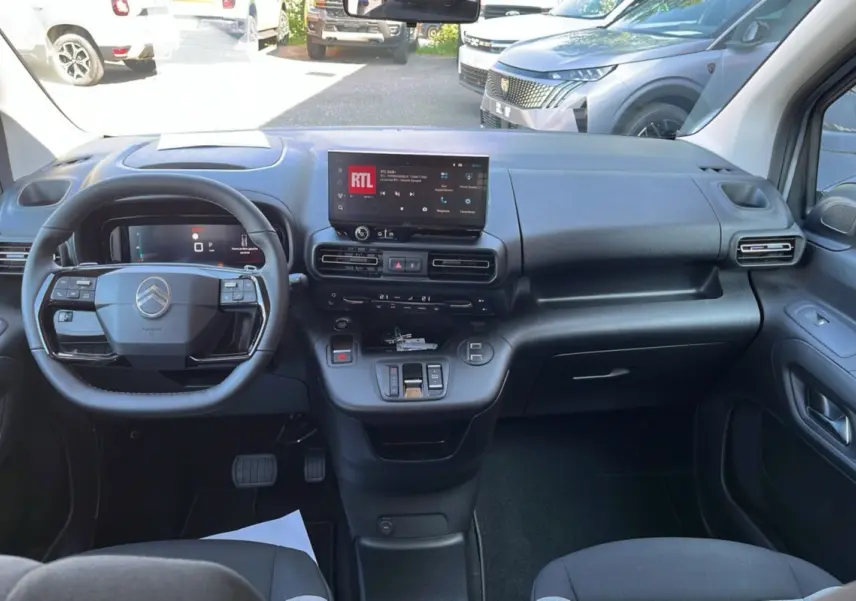 Vue intérieure avant du Citroën Berlingo 2025 avec tableau de bord moderne et écran tactile central.