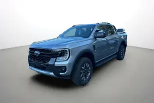 Ford Ranger PHEV gris iconic en 3/4 avant droit, double cabine avec jantes alu et barres de toit visibles.