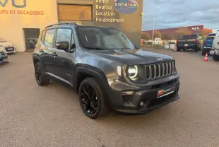 Jeep Renegade gris anthracite en 3/4 avant droit avec jantes alliage noires et barres de toit visibles.