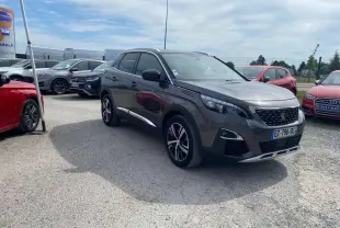 Peugeot 3008 gris platinium en 3/4 avant droit, avec barres de toit aluminium et projecteurs LED visibles.