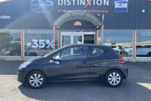 Profil côté gauche d'une Peugeot 208 gris foncé 2018 garée devant un concessionnaire Distinxion.