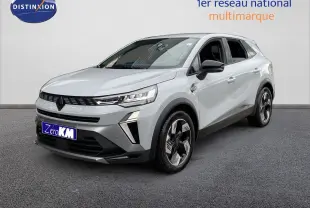 Renault Symbioz gris Rafale métal en 3/4 avant droit, SUV hybride avec calandre noire et jantes bicolores distinctives.