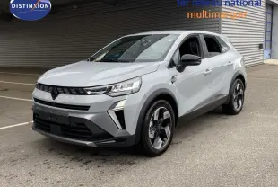 Renault Symbioz gris Rafale métal en 3/4 avant droit, SUV hybride avec jantes bicolores et calandre noire distinctive.