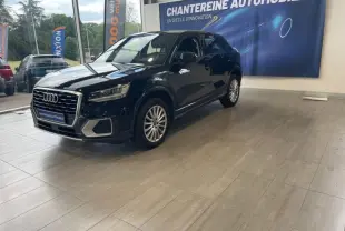 Audi Q2 noir brillant vue 3/4 avant droit en showroom avec jantes alliage et calandre chromée.