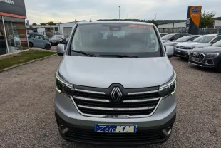 Vue frontale d'un Renault Trafic Fourgon gris clair avec calandre chromée et feux LED en C-Shape.