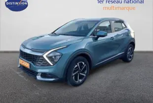 Vue 3/4 avant d'un KIA Sportage gris Sirius metal avec feux LED en forme de flèche et jantes bi-ton.