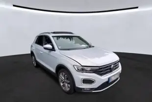 Volkswagen T-Roc Silver White en 3/4 avant droit avec jantes alu 18 pouces et toit ouvrant panoramique visible.
