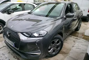 DS3 Crossback gris platinium en 3/4 avant droit, avec calandre hexagonale et logo DS bien visible.