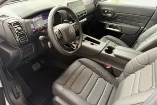Vue intérieure côté conducteur du Citroën C5 Aircross 2025, sièges gris et tableau de bord avec écran tactile.