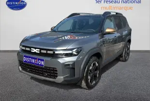 SUV Dacia Bigster gris schiste en 3/4 avant droit avec jantes alu et rétroviseurs bronze métallisé.