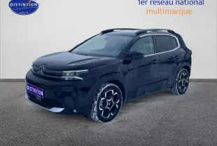Citroën C5 Aircross noir vue 3/4 avant droit avec jantes alu et barres de toit visibles.