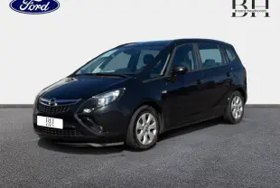 Opel Zafira Tourer gris métal vue 3/4 avant droit sur fond neutre avec jantes argentées visibles.