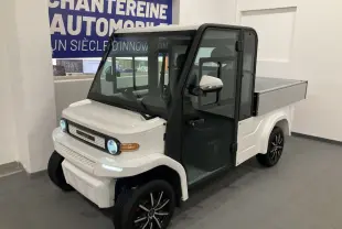 Vue 3/4 avant droite du pick-up électrique blanc Liberty L7E H2 160 avec kit ridelles et jantes alliage 13 pouces.