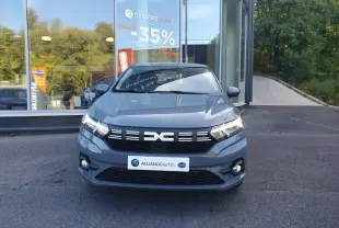Vue avant d'une Dacia Sandero gris urbain 2024 avec signature lumineuse LED et calandre noire distinctive.