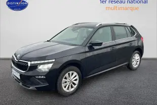 Vue 3/4 avant d'un Skoda Kamiq noir 2025 avec calandre chromée et jantes alu sur sol gris.