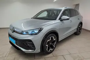 Volkswagen Tiguan 2.0 TDI 150 DSG7 R-Line argent Dolomite, vue 3/4 avant avec phares LED Matrix allumés.