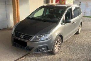 Vue 3/4 avant droit d'un SEAT Alhambra gris 2017 avec calandre noire et jantes alliage visibles.