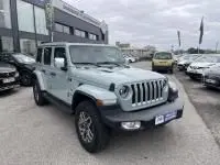 Jeep Wrangler Unlimited 2023 vert métal en 3/4 avant, hybride rechargeable, avec calandre à sept fentes et roues tout-terrain.