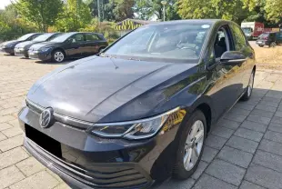 Volkswagen Golf VIII 2.0 TDI noire vue en 3/4 avant droit sur un parking ensoleillé.