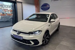 Volkswagen Polo 2024 blanche vue 3/4 avant en intérieur avec jantes alliage R-Line et calandre spécifique.