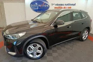 BMW X1 sDrive18i noir en 3/4 avant droit, avec jantes alliage et rétroviseurs rabattables électriquement.