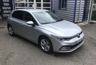 Volkswagen Golf VIII gris reflex vue 3/4 avant droit, avec jantes alliage et calandre moderne.