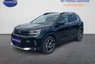 Vue 3/4 avant d'un Citroën C5 Aircross noir métal 2025 avec jantes bi-ton et détails chromés sur le bouclier.