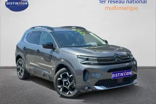 Citroën C5 Aircross gris Platinium en 3/4 avant droit avec jantes alu et barres de toit visibles.