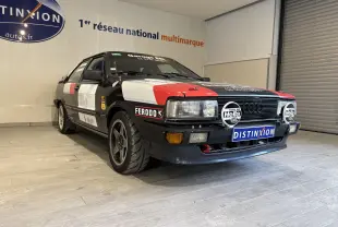 Audi Coupé GT noir vue 3/4 avant droit avec stickers rallye rouges et blancs et phares additionnels Hella.