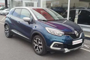 Vue 3/4 avant droite d'un Renault Captur 2018 bleu marine fumé avec toit gris platine et jantes bi-ton.