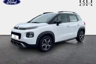 Citroën C3 Aircross blanc Natural White vue 3/4 avant droit avec barres de toit et jantes distinctives.