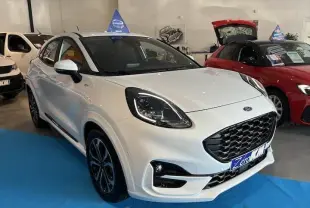Ford Puma blanc glacier vu en 3/4 avant droit dans un showroom avec calandre noire et jantes alliage.