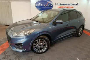 Vue 3/4 avant d'un Ford Kuga bleu 2024 finition St Line avec jantes alliage et vitres teintées en showroom.