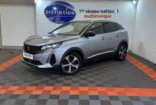 Peugeot 3008 BlueHDi 130 GT gris clair vue 3/4 avant droit en intérieur avec logo Distinxion en arrière-plan