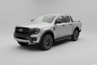 Ford Ranger Wildtrak gris en vue 3/4 avant droit, avec barres de toit et jantes alliage noires.