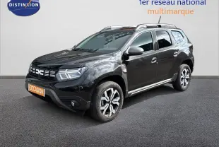 Dacia Duster noir en 3/4 avant droit, mettant en valeur ses jantes bicolores et sa calandre distinctive.