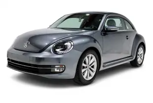 Volkswagen Coccinelle gris métallisé vue 3/4 avant droit avec phares LED et jantes alliage 16 pouces.